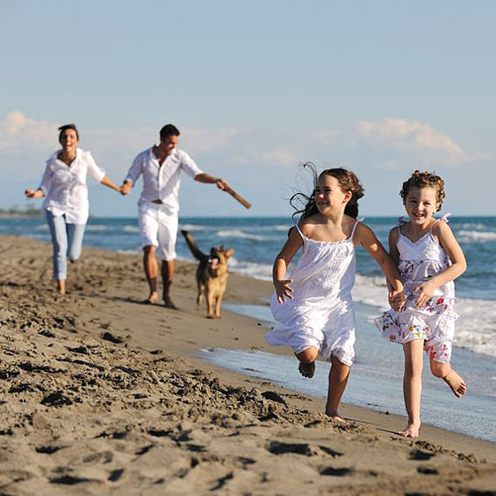 family enjoying an afternoon at the beach