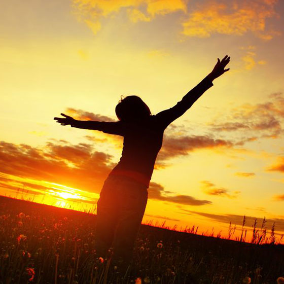 healthy woman, silhouetted at sunset