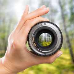 hand holding a camera lens